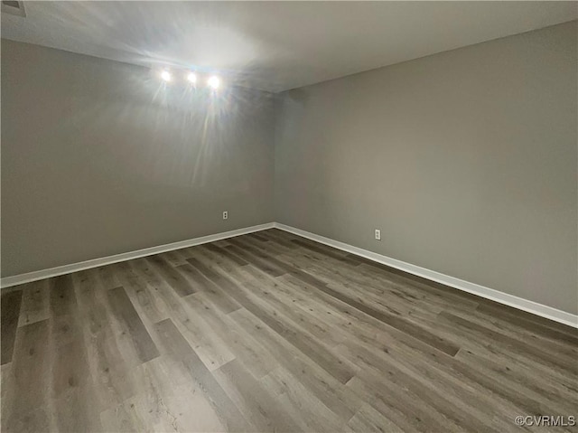 spare room with wood-type flooring