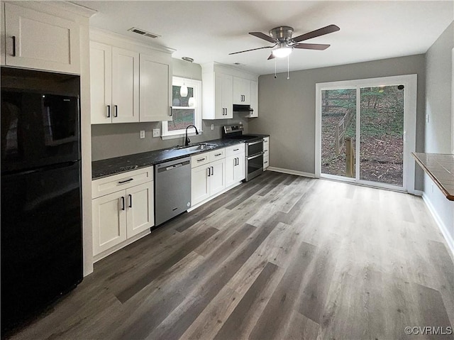 kitchen with appliances with stainless steel finishes, white cabinetry, and sink