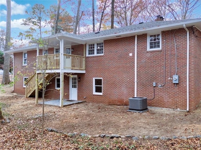 rear view of house with cooling unit and a wooden deck