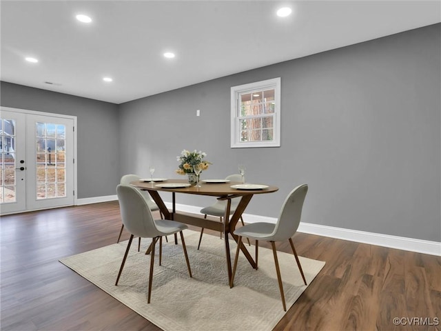 dining area with dark hardwood / wood-style floors and french doors