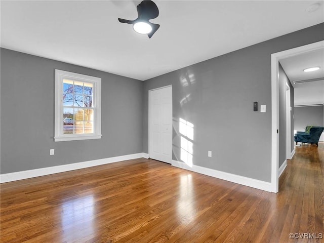 empty room featuring ceiling fan and dark hardwood / wood-style floors