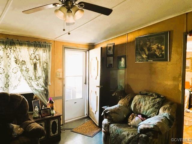 interior space with ceiling fan