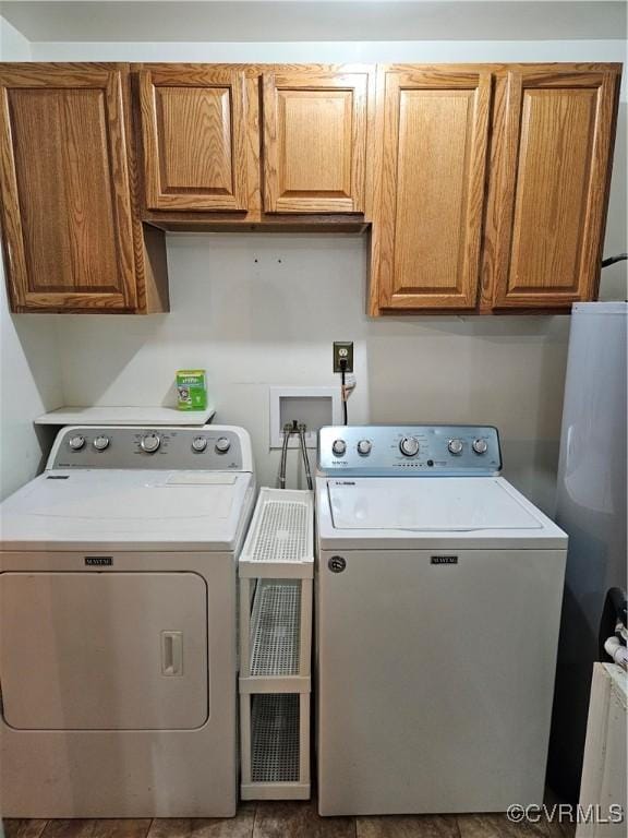 laundry room featuring washing machine and dryer and cabinets