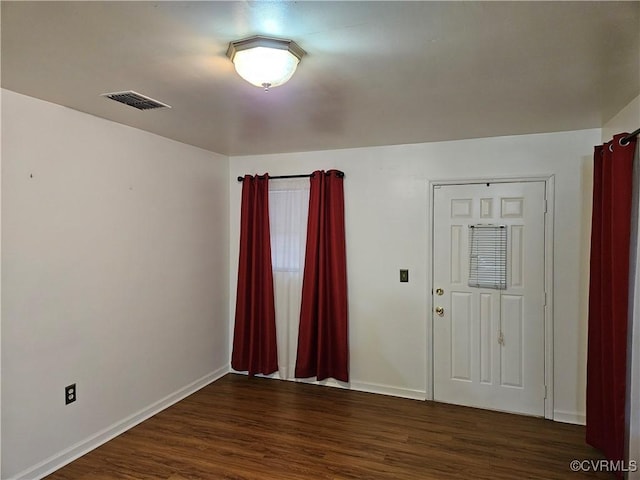 spare room with dark hardwood / wood-style floors