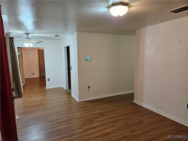 empty room with ceiling fan and dark hardwood / wood-style floors