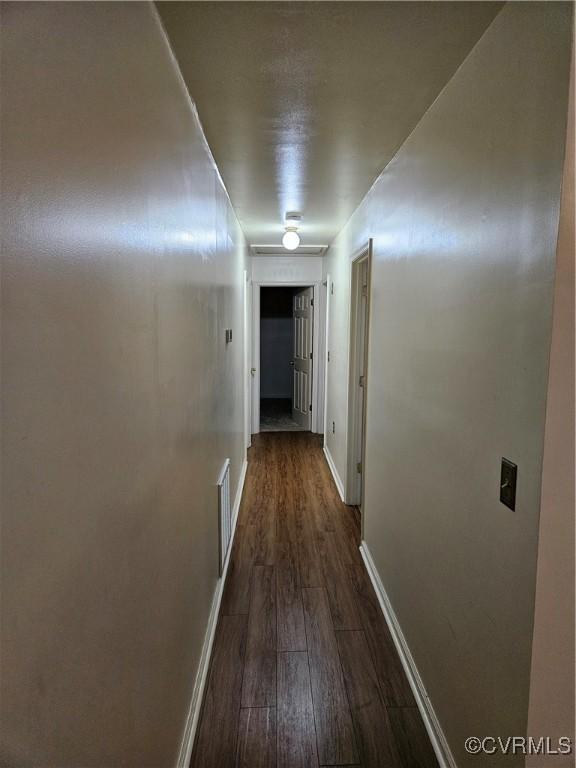 corridor with dark wood-type flooring