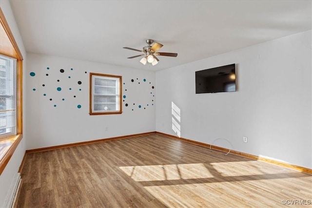 unfurnished room featuring ceiling fan and hardwood / wood-style flooring