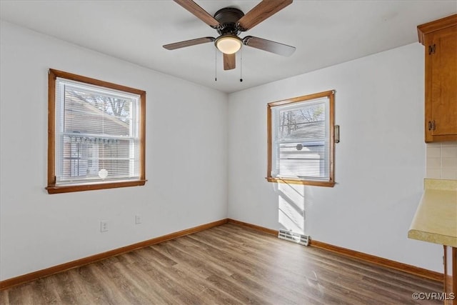 spare room featuring ceiling fan and hardwood / wood-style floors