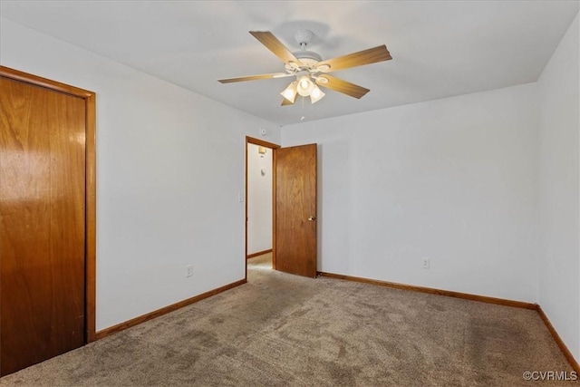 unfurnished bedroom featuring ceiling fan, light carpet, and a closet