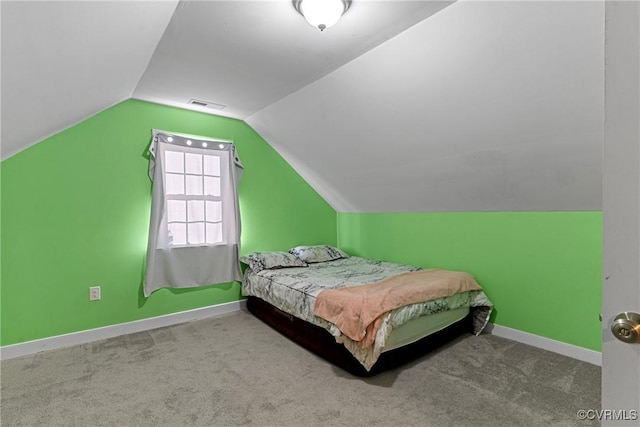 carpeted bedroom featuring vaulted ceiling