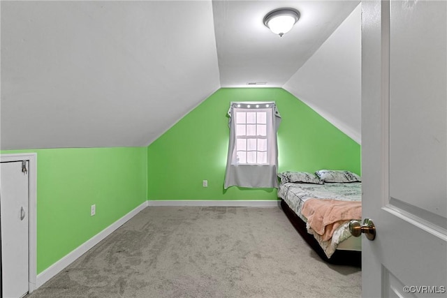 bedroom with lofted ceiling and light carpet