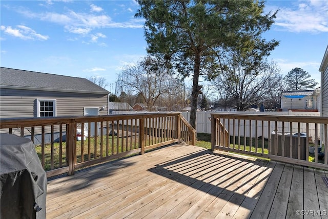 deck with area for grilling, a shed, and cooling unit