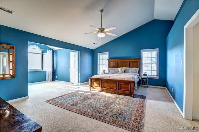 carpeted bedroom with ceiling fan and vaulted ceiling