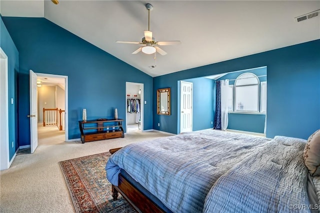 bedroom with carpet flooring, ceiling fan, lofted ceiling, a walk in closet, and a closet