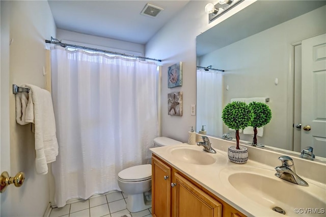 bathroom with tile patterned flooring, vanity, and toilet