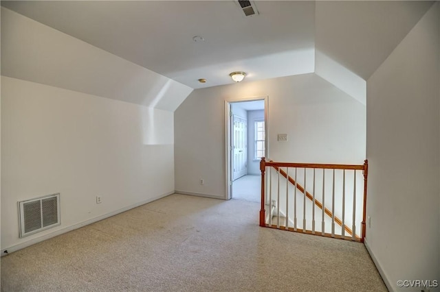 additional living space with light colored carpet and lofted ceiling