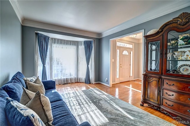 interior space with light hardwood / wood-style floors and ornamental molding