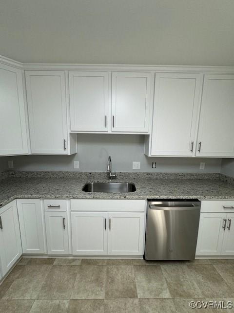 kitchen featuring light stone counters, dishwasher, white cabinets, and sink