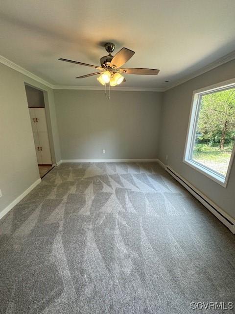 unfurnished bedroom featuring carpet flooring, baseboard heating, crown molding, and ceiling fan