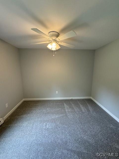 spare room featuring ceiling fan and carpet