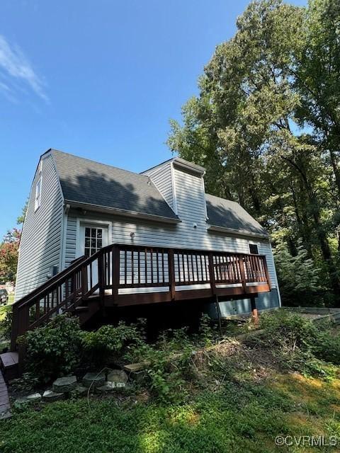 rear view of property with a wooden deck