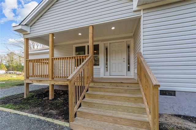 view of exterior entry with covered porch