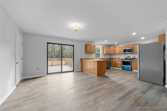 kitchen with sink, light hardwood / wood-style flooring, and appliances with stainless steel finishes