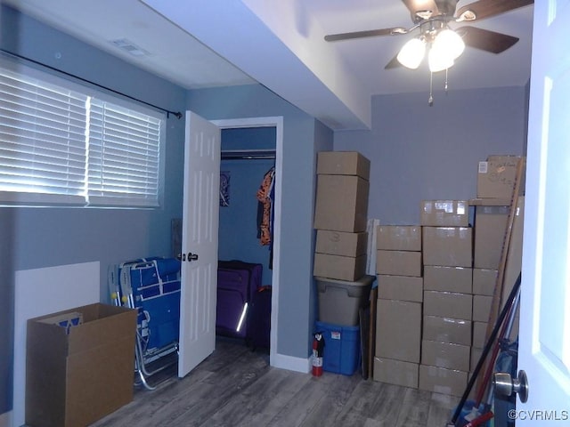 bedroom with hardwood / wood-style floors, ceiling fan, and a closet