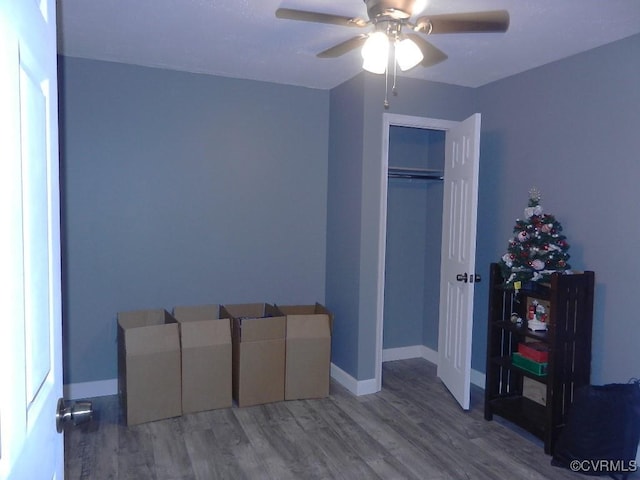 unfurnished bedroom featuring wood-type flooring, a closet, and ceiling fan