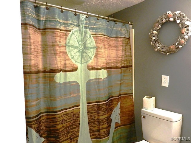 bathroom with a textured ceiling and toilet