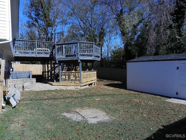 view of yard with a wooden deck and a storage unit