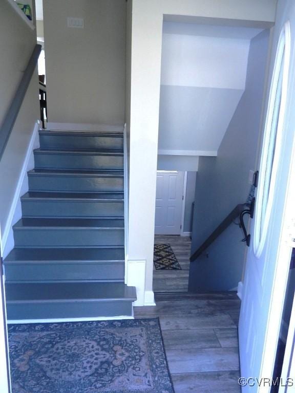 stairway with hardwood / wood-style floors