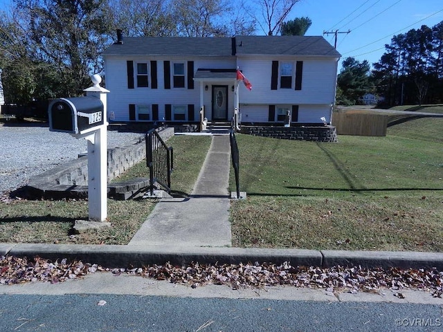 split foyer home featuring a front lawn