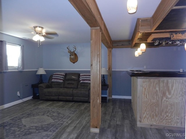 living room featuring dark wood-type flooring and ceiling fan