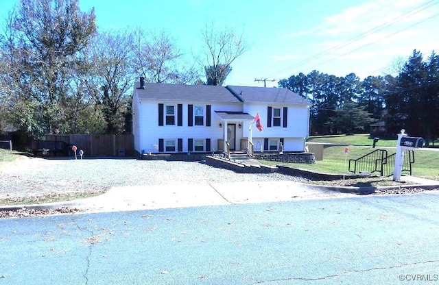 raised ranch with a front lawn