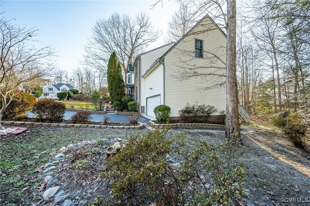 view of side of home with a garage