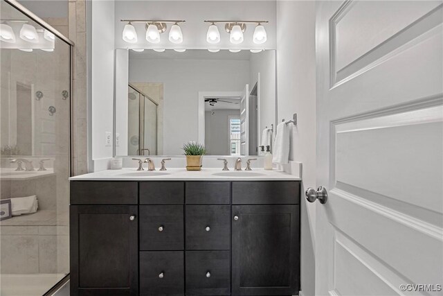 bathroom with vanity and a shower with shower door