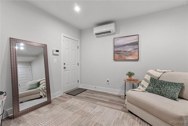 entrance foyer with light hardwood / wood-style flooring and an AC wall unit