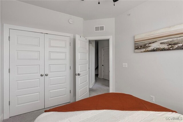 unfurnished bedroom with light carpet and a closet