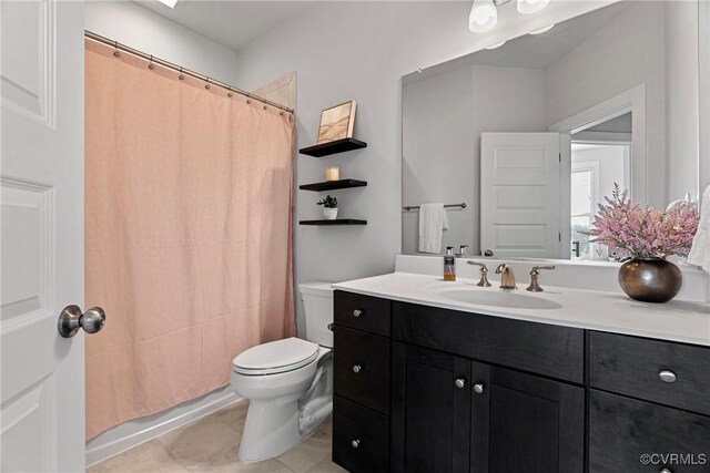 bathroom with vanity, tile patterned floors, toilet, and walk in shower