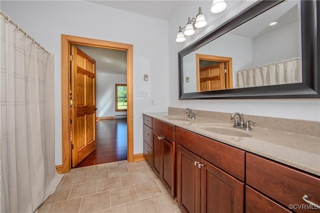 bathroom with vanity, a baseboard radiator, and tile patterned floors