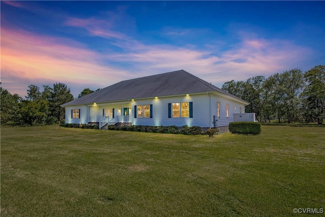 view of front of house with a porch and a lawn