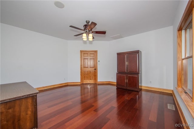 empty room with ceiling fan and dark wood-type flooring