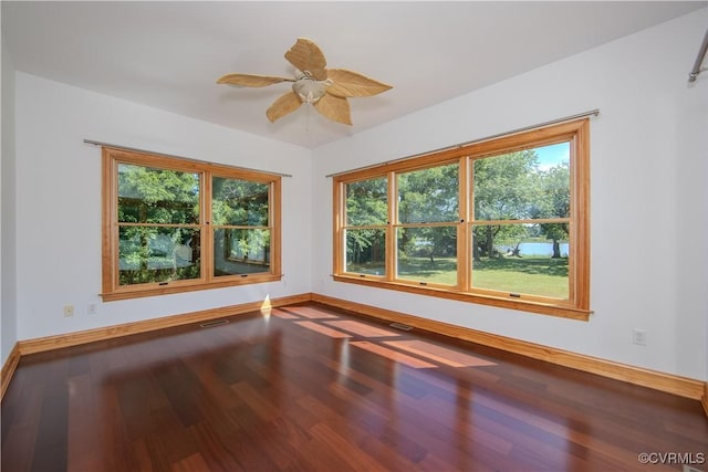 empty room with ceiling fan and wood-type flooring