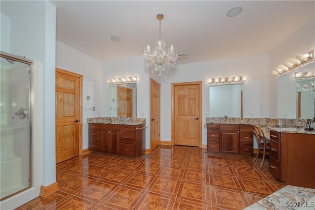 bathroom with vanity, a chandelier, and an enclosed shower