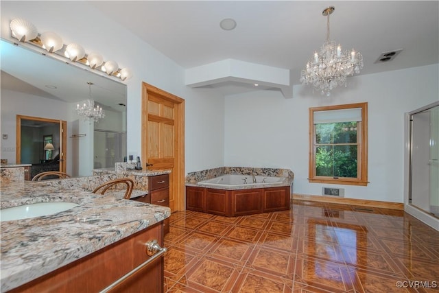 bathroom featuring tile patterned flooring, a bath, vanity, and a notable chandelier