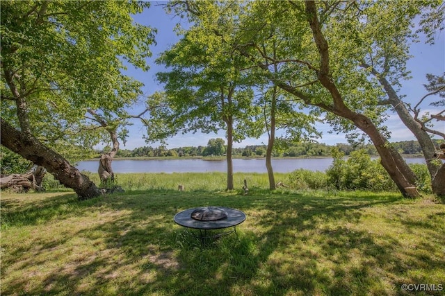 view of yard with a fire pit and a water view