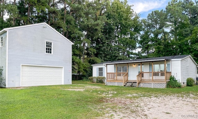 view of front facade with a garage, covered porch, and a front yard