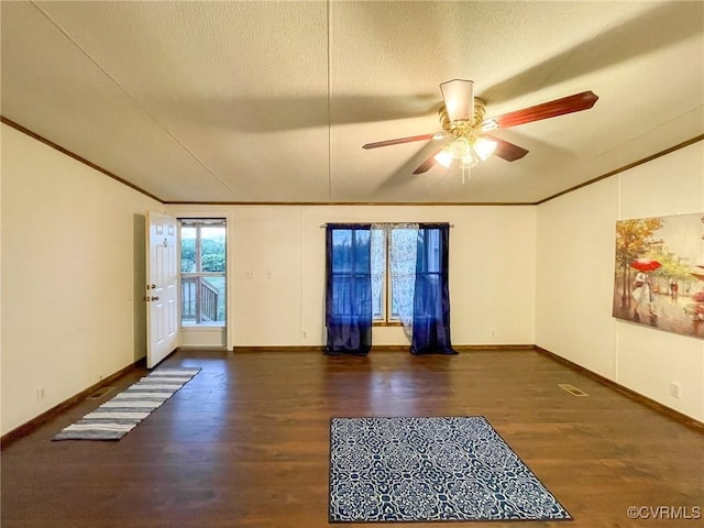 spare room featuring ceiling fan and dark hardwood / wood-style flooring