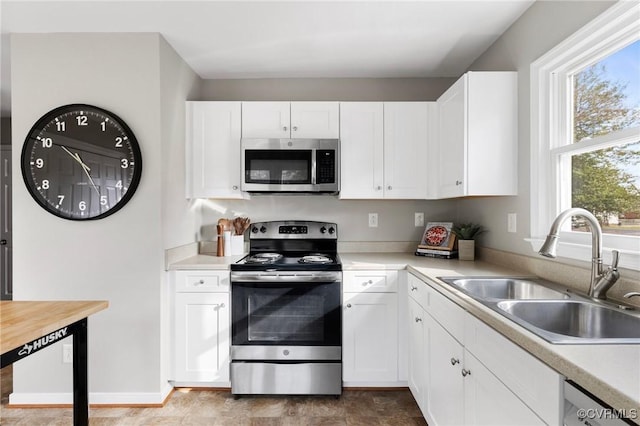 kitchen featuring white cabinets, appliances with stainless steel finishes, and sink